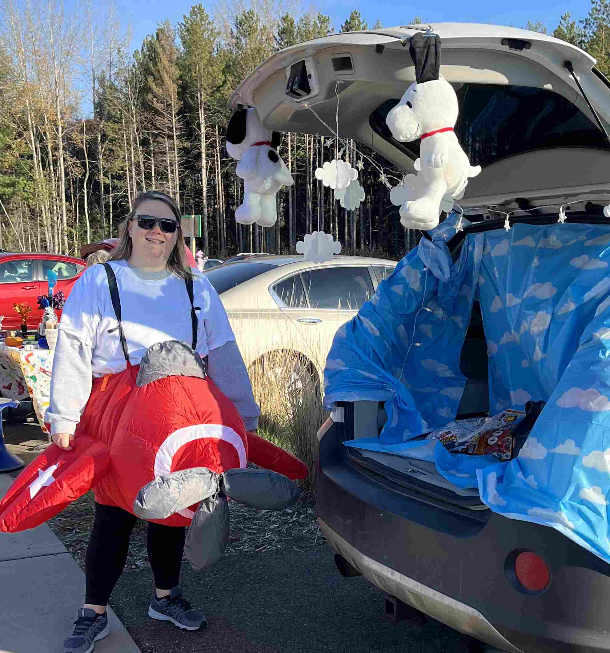 Teacher wearing an inflatable plane costume to be Snoopy, WWI Flying Ace