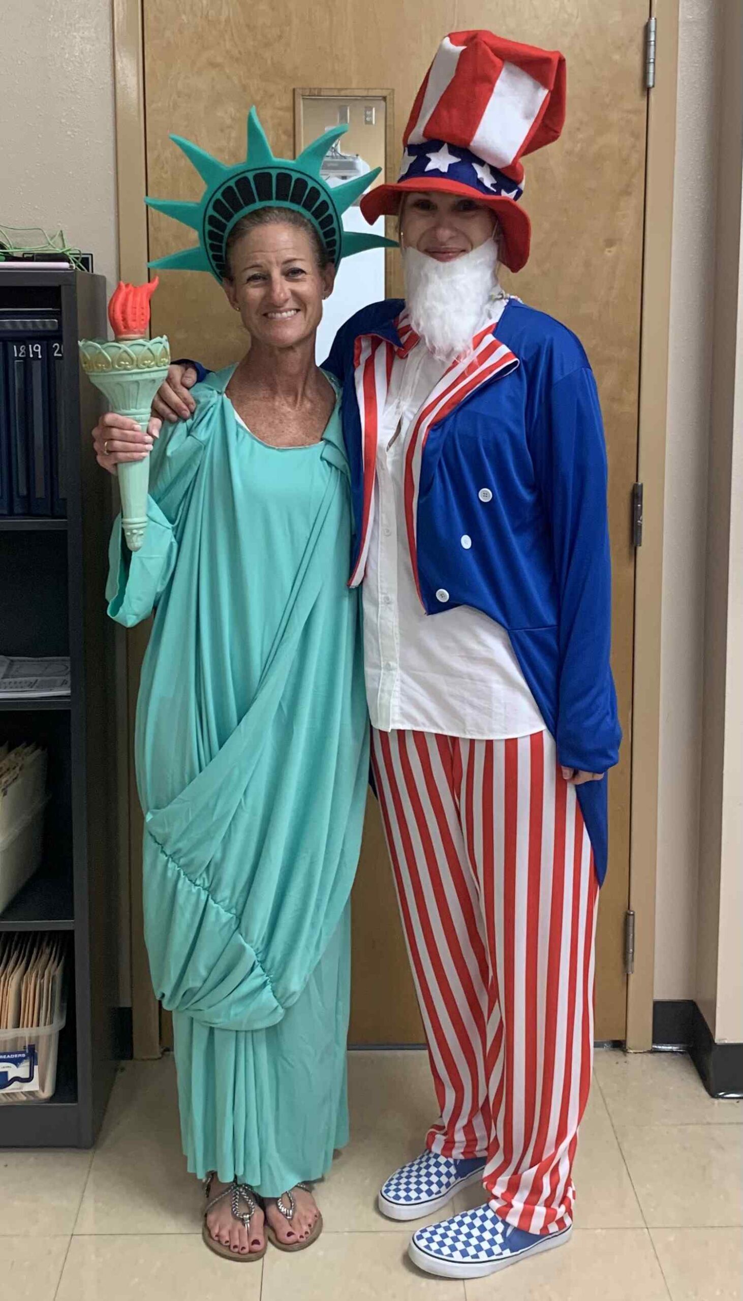 Two teachers dressed for Halloween as Lady Liberty and Uncle Sam