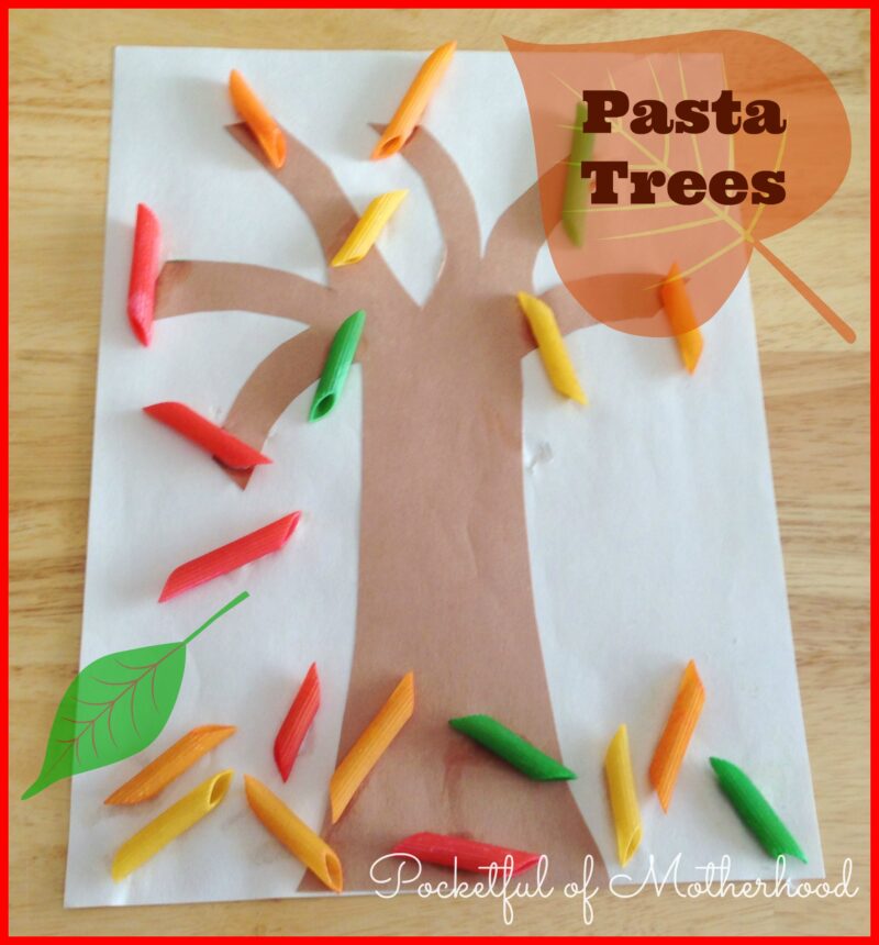 A tree is made from cutout brown paper. the leaves are macaroni that have been painted red, orange, and green.