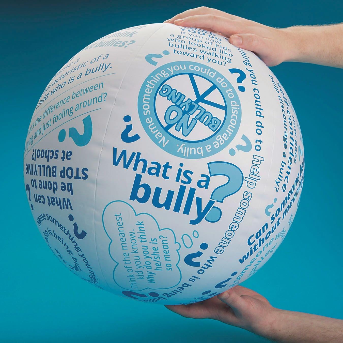 Student holding an inflatable ball with questions about bullying printed on it