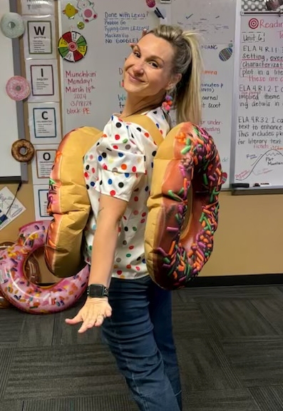 Teacher wearing a plush donut costume