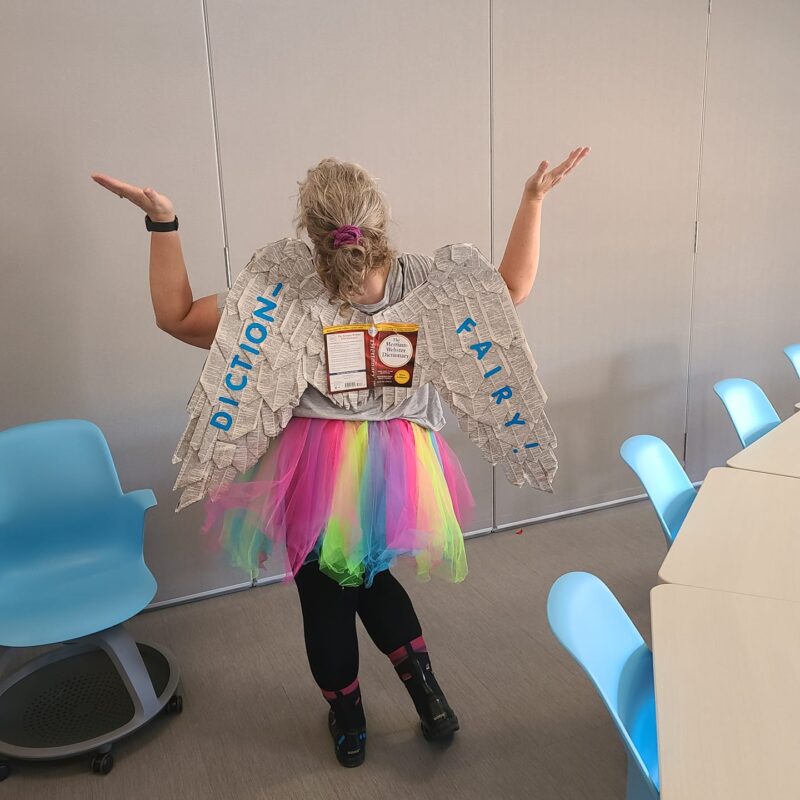 Teacher dressed as a Diction-Fairy, with wings covered in book pages