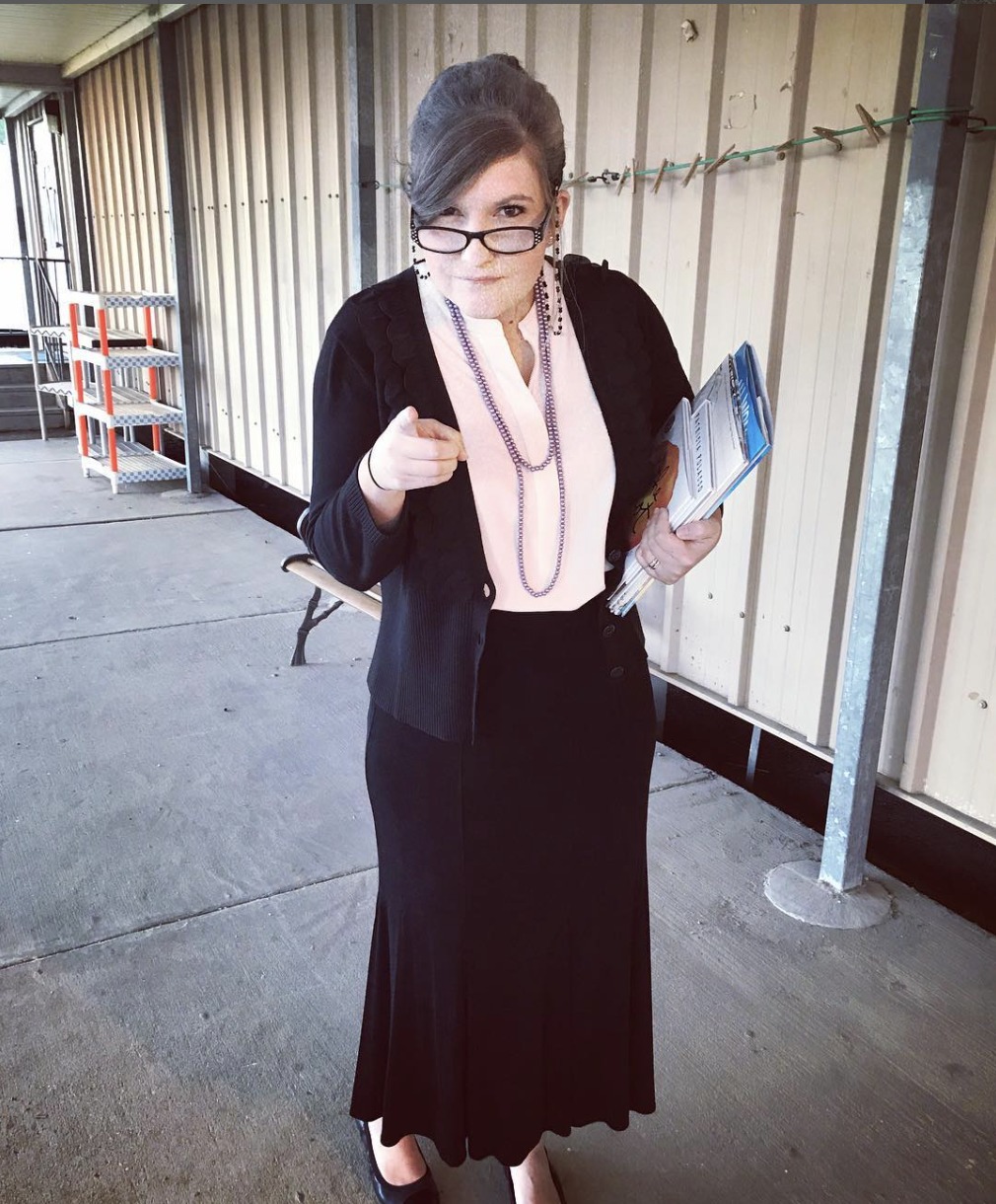 Teacher dressed as a stereotypical grumpy old librarian for Halloween