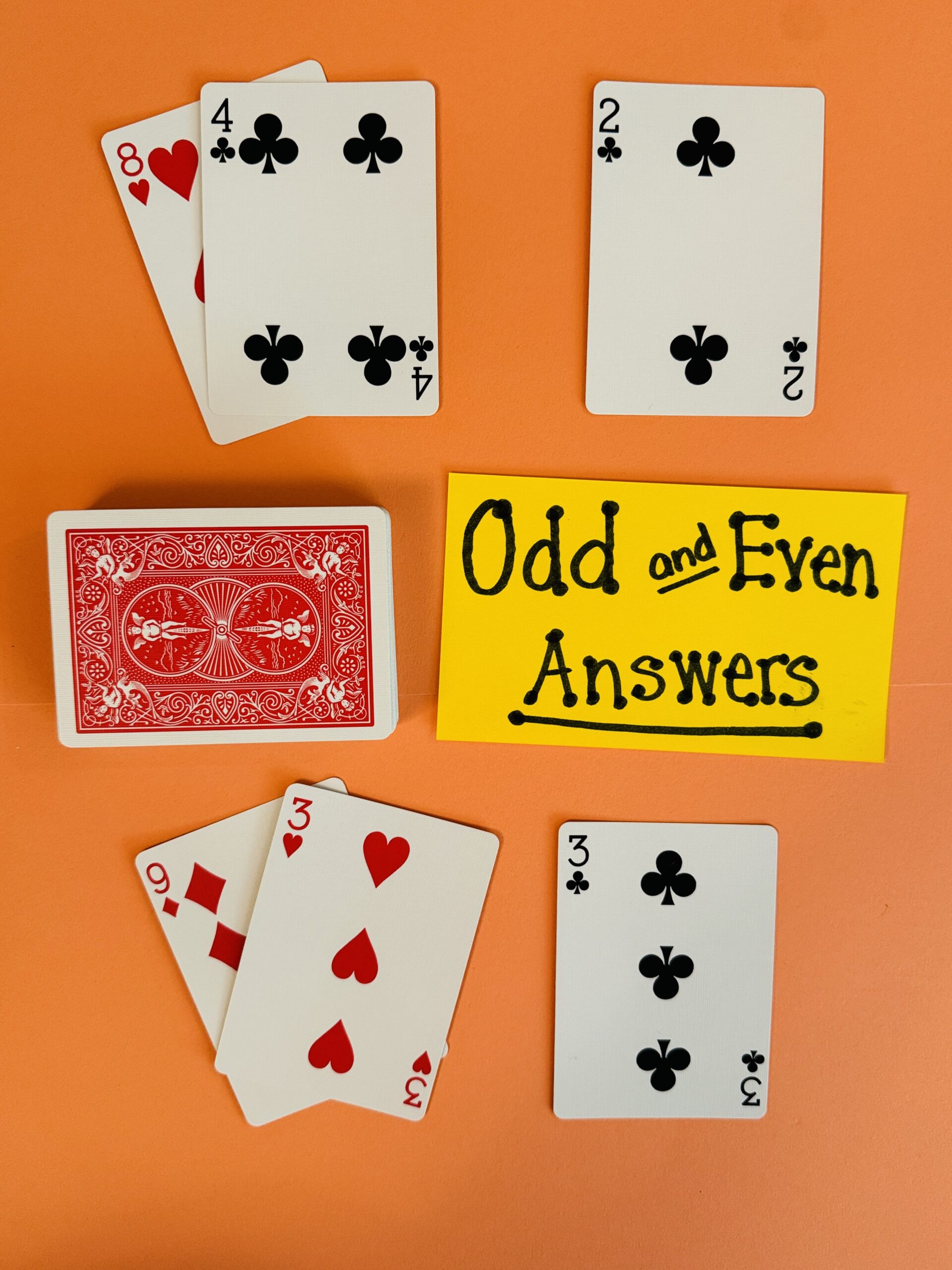 Deck of cards and a flashcard with the words Odd and Even Answers