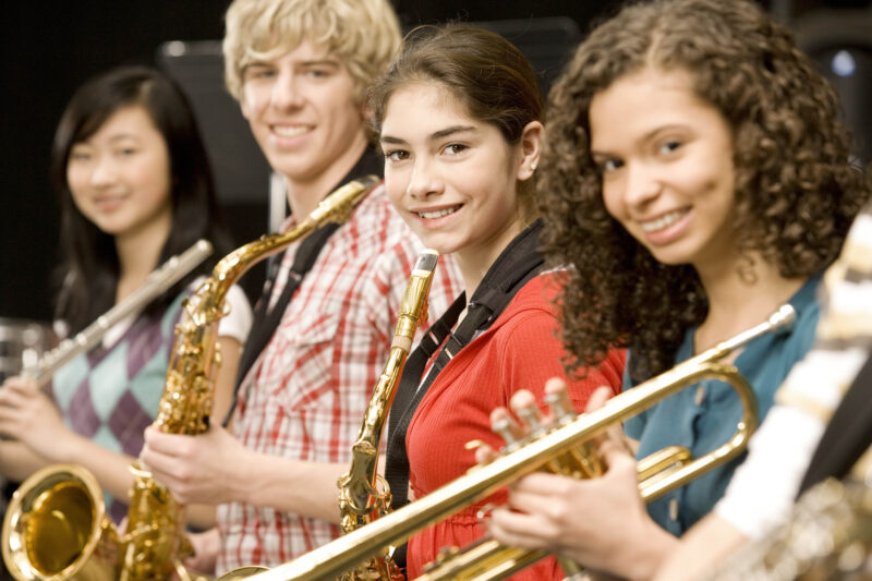 Teens holding musical instruments