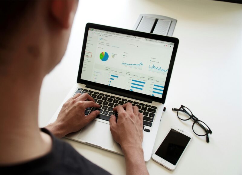 An actuary uses a laptop to analyze financial data